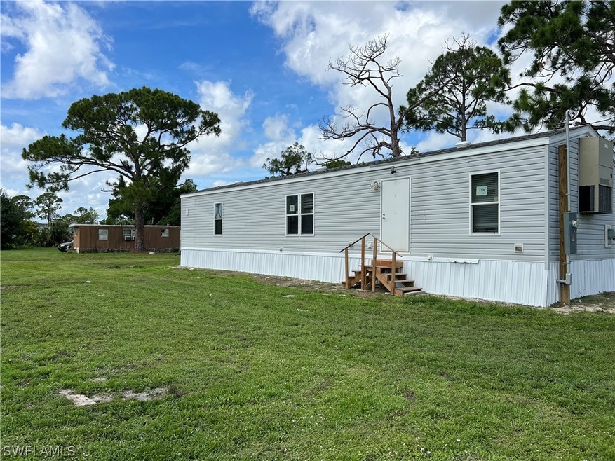 Back of house with a yard