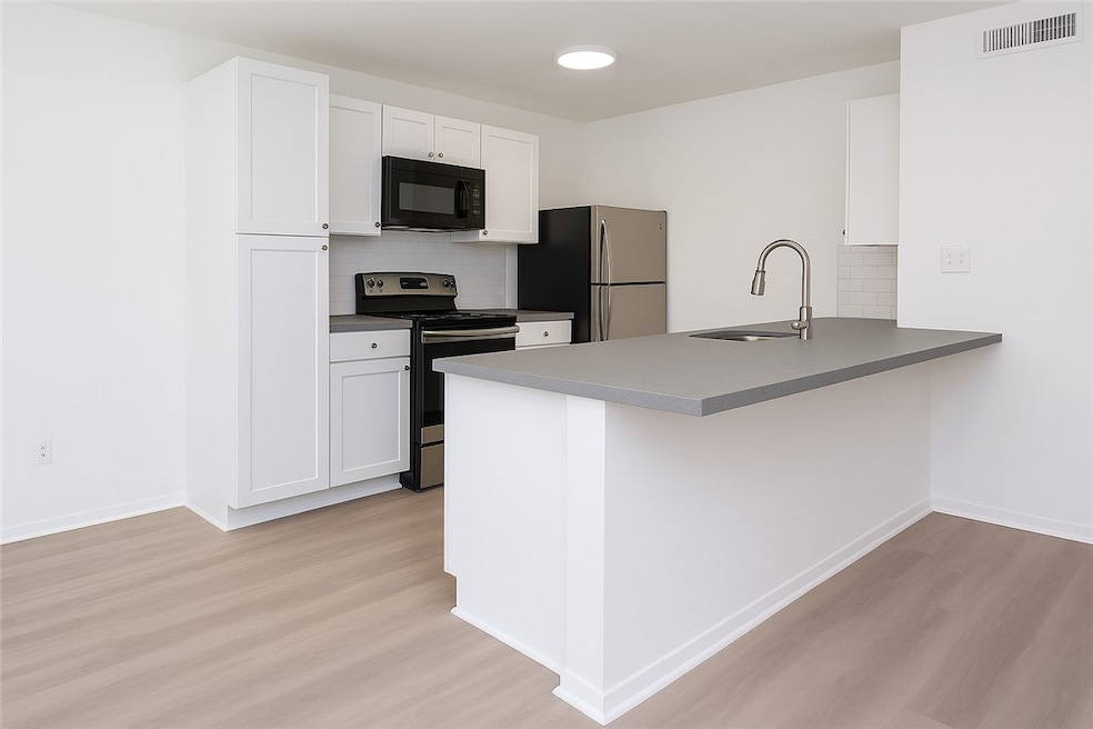 Kitchen with appliances with stainless steel finis