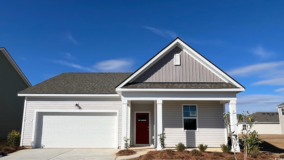 View of front of house featuring concrete driveway, roof with shingles, a porch, and board and batten siding