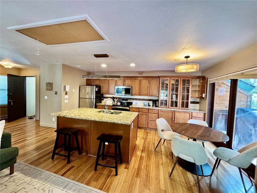 Kitchen featuring light wood finished floors, a si
