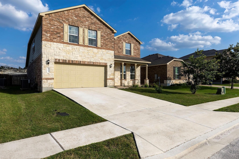 Traditional-style house with driveway, a front ya