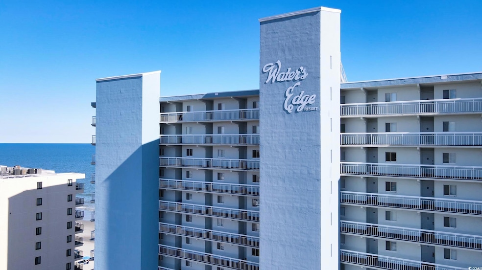 View of apartment building / complex with a water view