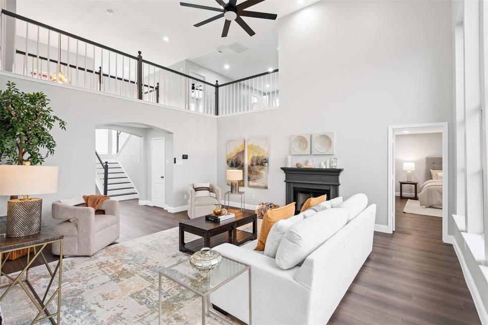 Living room featuring ceiling fan, dark hardwood /