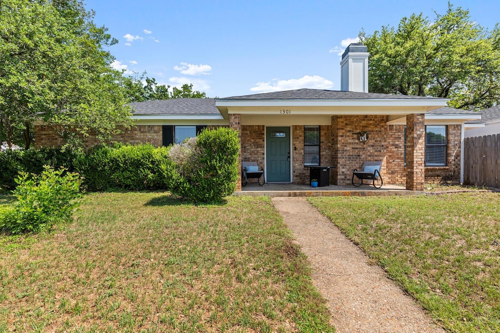 View of front of home featuring brick siding, a c