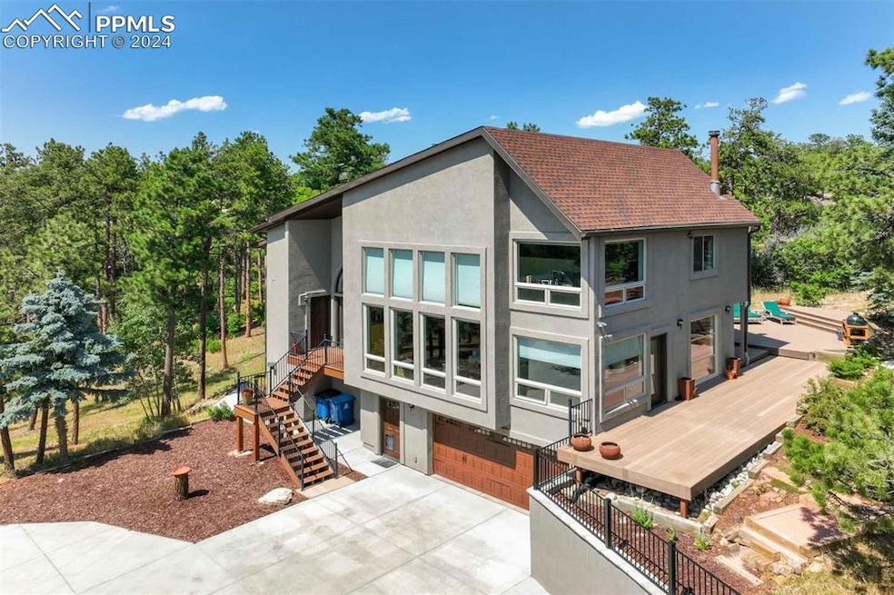 Back of property featuring a garage