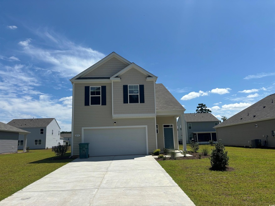 View of front of property with a front yard and a 