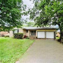 View of front of home featuring a garage and a front lawn