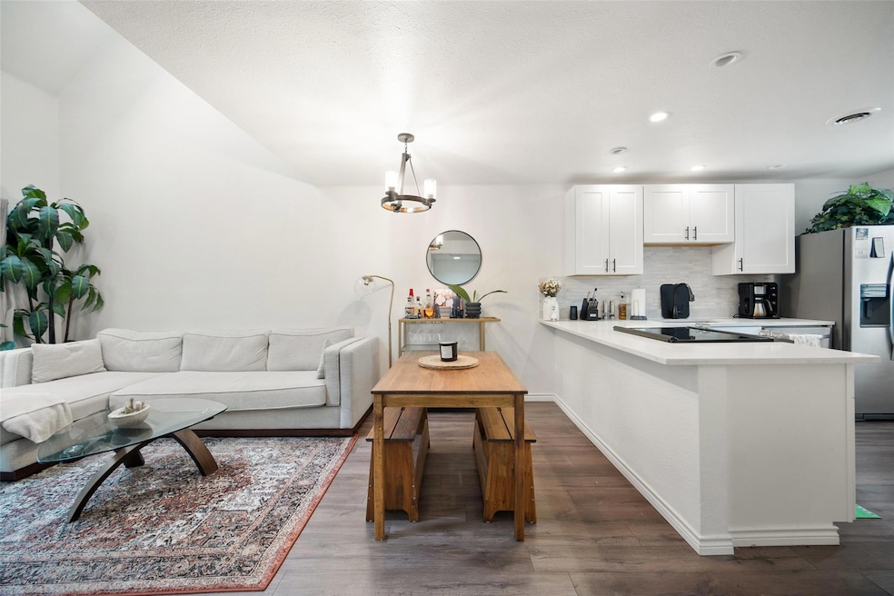 Living room with dark wood-style flooring, a chan