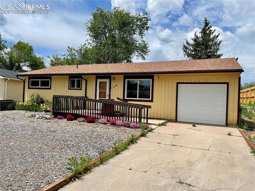 Single story home with a garage, fence, a shingled
