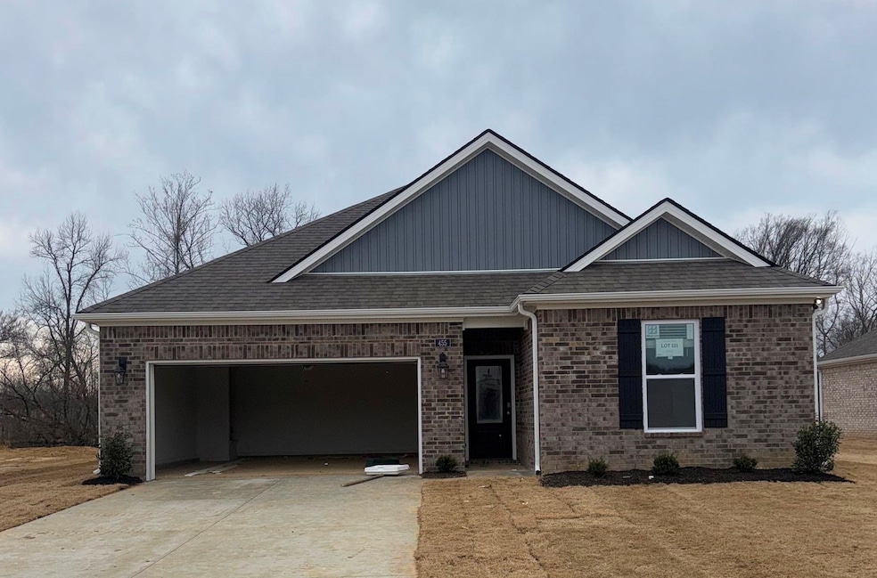 View of front of home featuring driveway, an attac