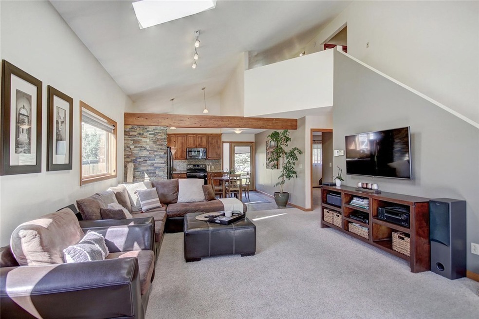 Living area! Vaulted ceilings and beautiful beam w