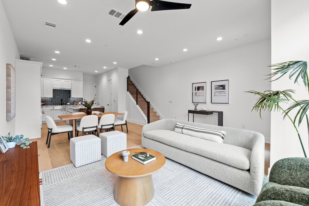 Living area featuring visible vents, light wood-t