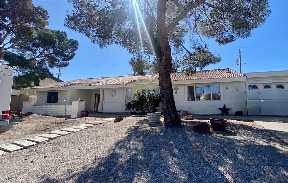 Single story home with stucco siding and a tile ro
