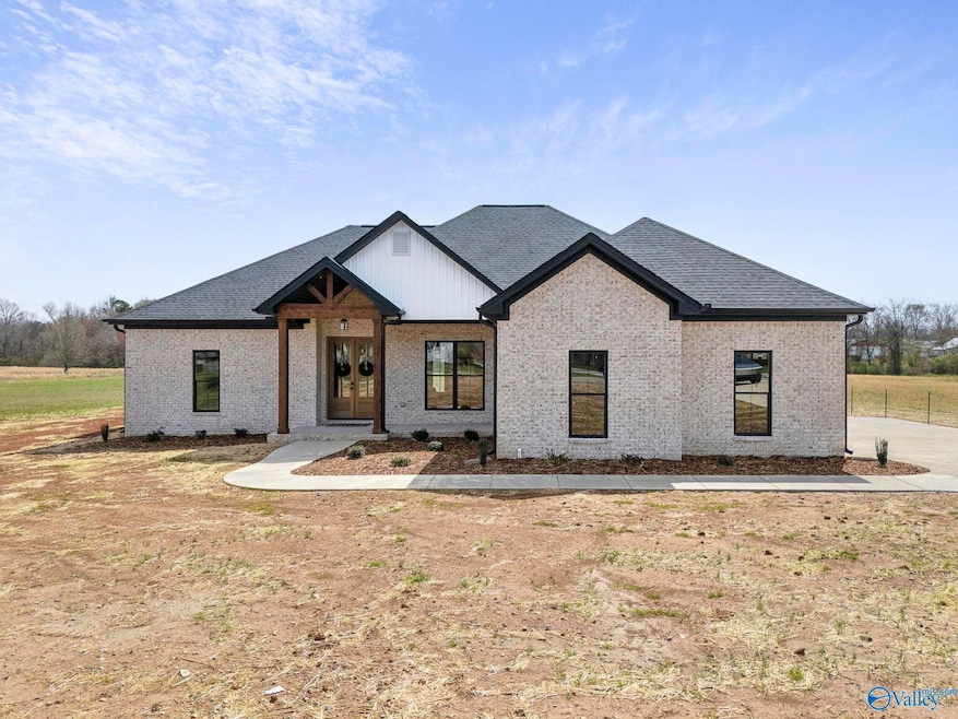 Stunning full brick facade w/ Western Cedar Columns frames the inviting craftsman style porch. Double Mahogony front doors appropriately greet your family & guests.