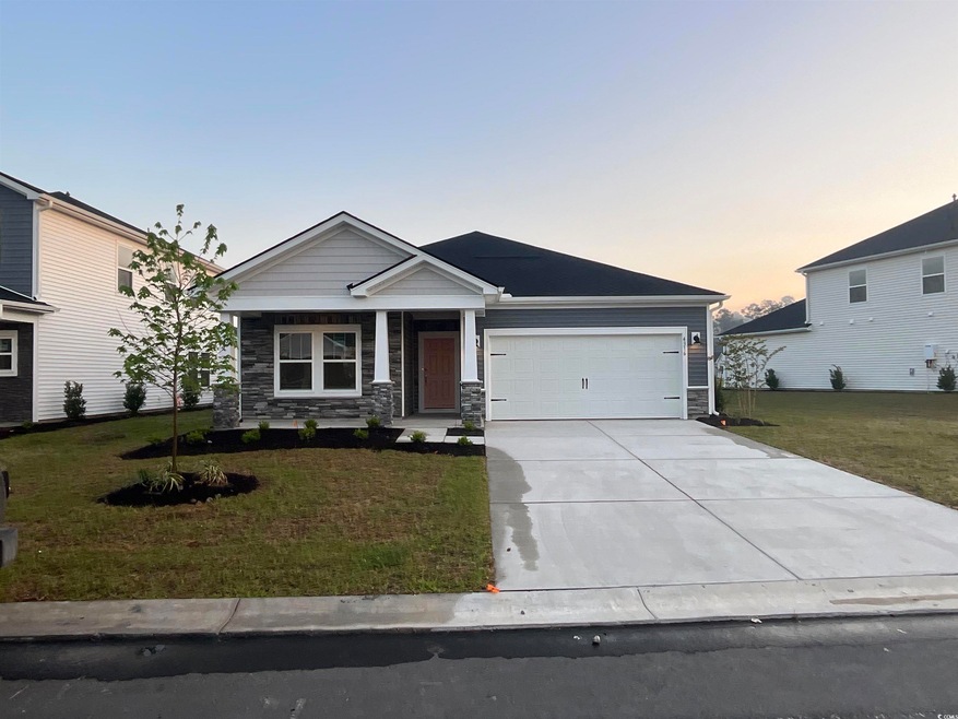 Craftsman inspired home with a front yard, a garag
