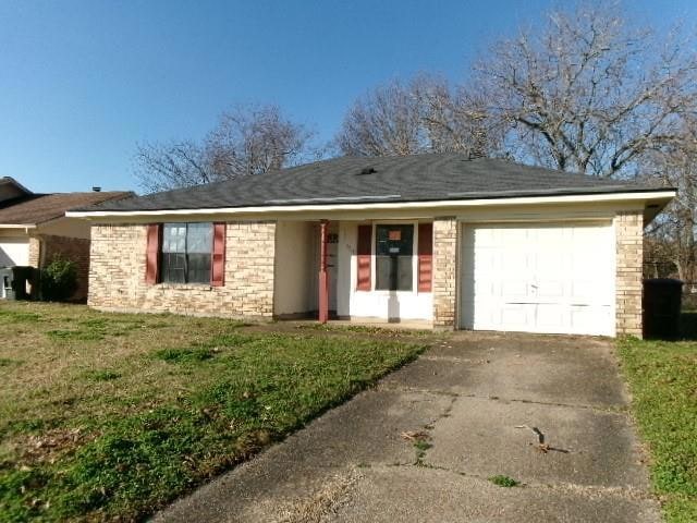 Ranch-style house with brick siding, a garage, a f
