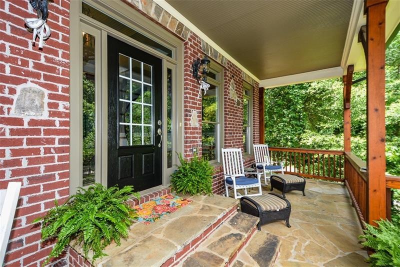 Beautiful covered front porch with wooded views in