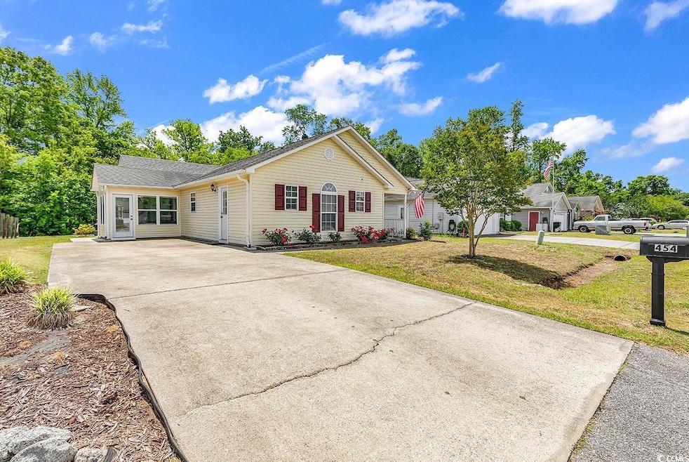 Single story home featuring concrete driveway, a f