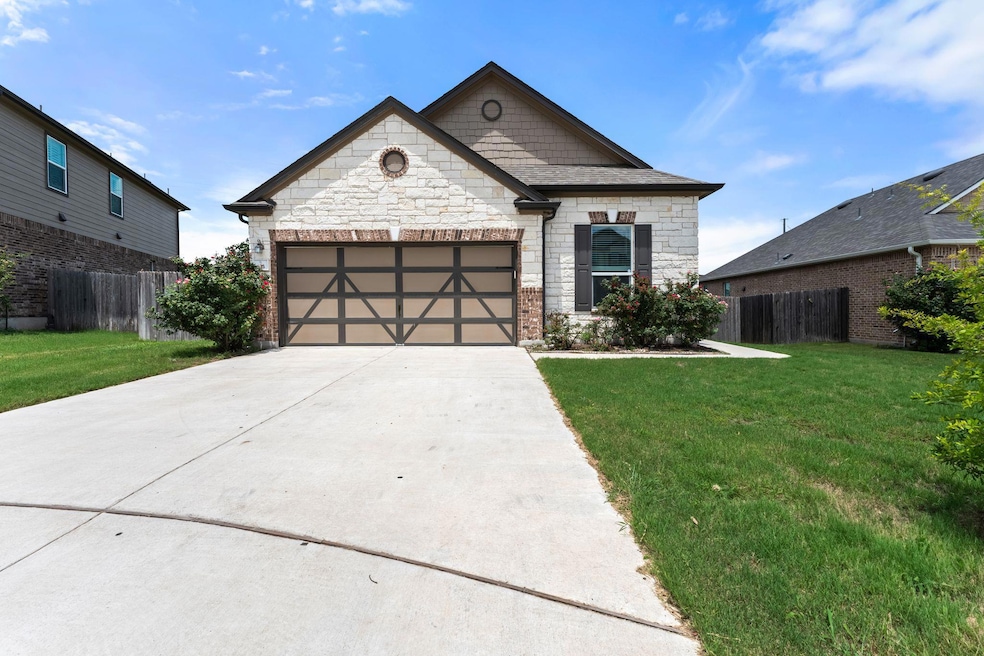 View of front facade featuring stone siding, conc