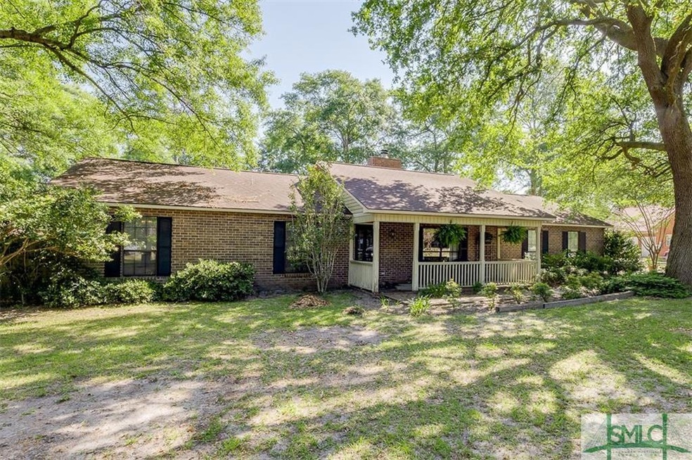 Exterior Front yard with lots of trees & the home 