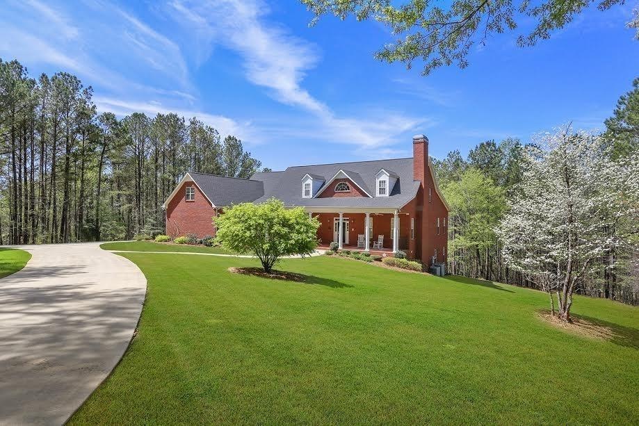 THIS HOME IS NESTLED BACK OFF THE ROAD AND HAS A C