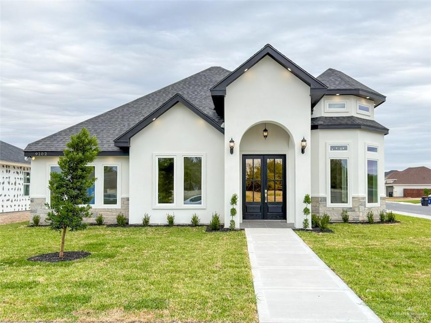 View of front of property with roof with shingles and a front lawn