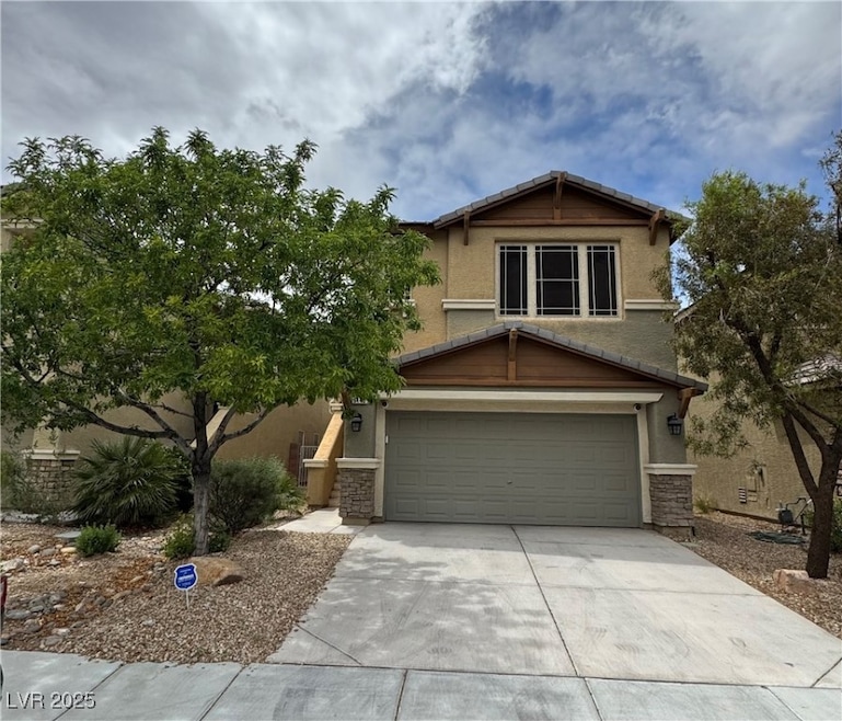 Craftsman-style house with driveway, stone siding,