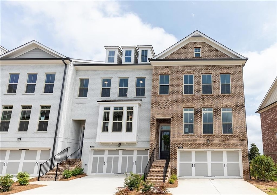 Multi unit property featuring a garage, brick sidi