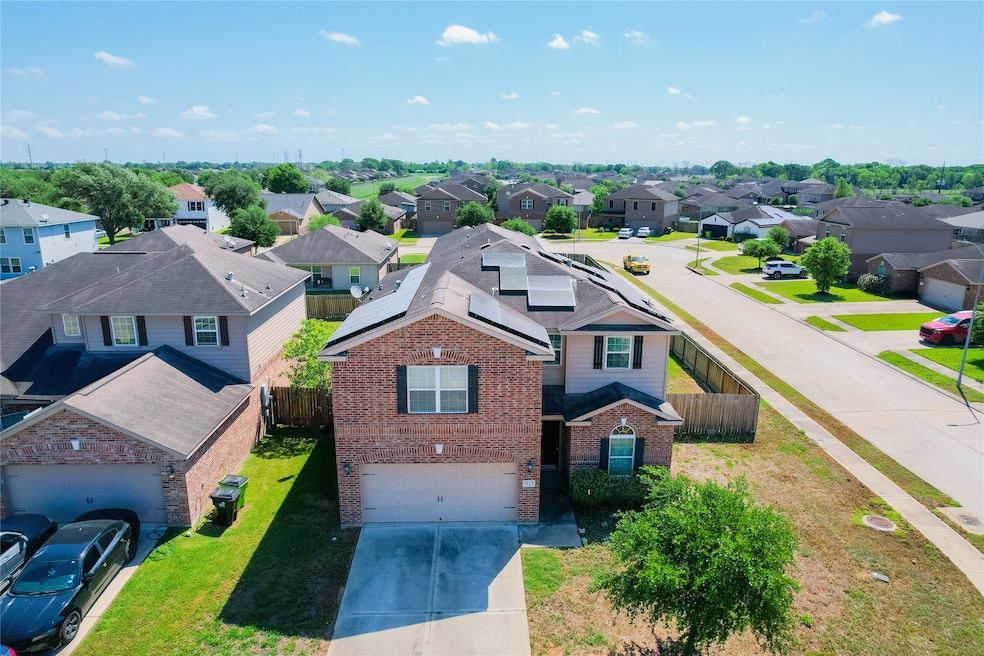 This photo shows a spacious two-story brick home w