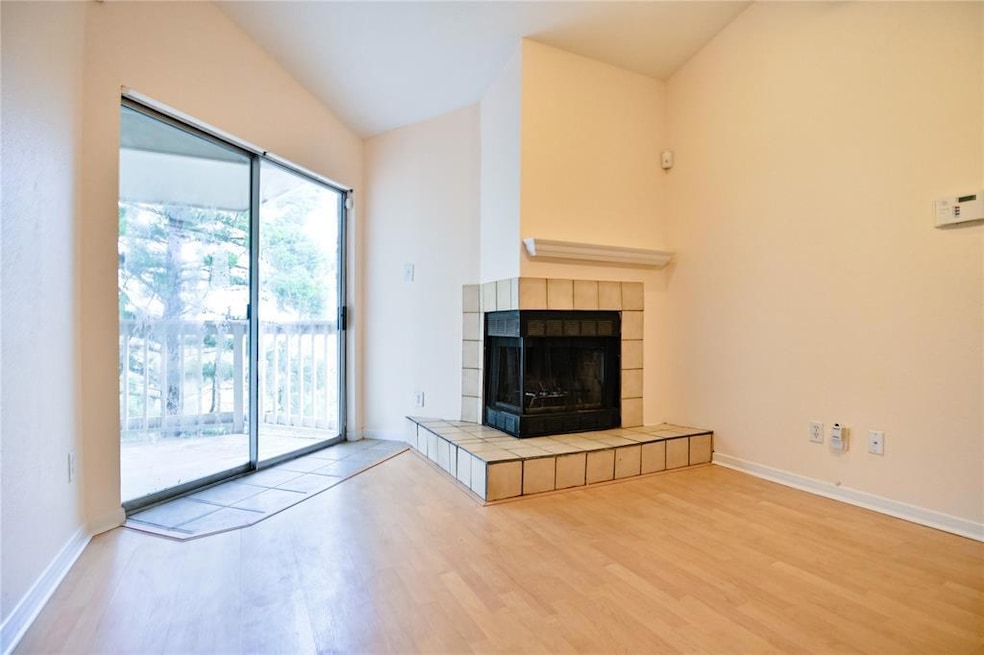 Unfurnished living room featuring wood finished f
