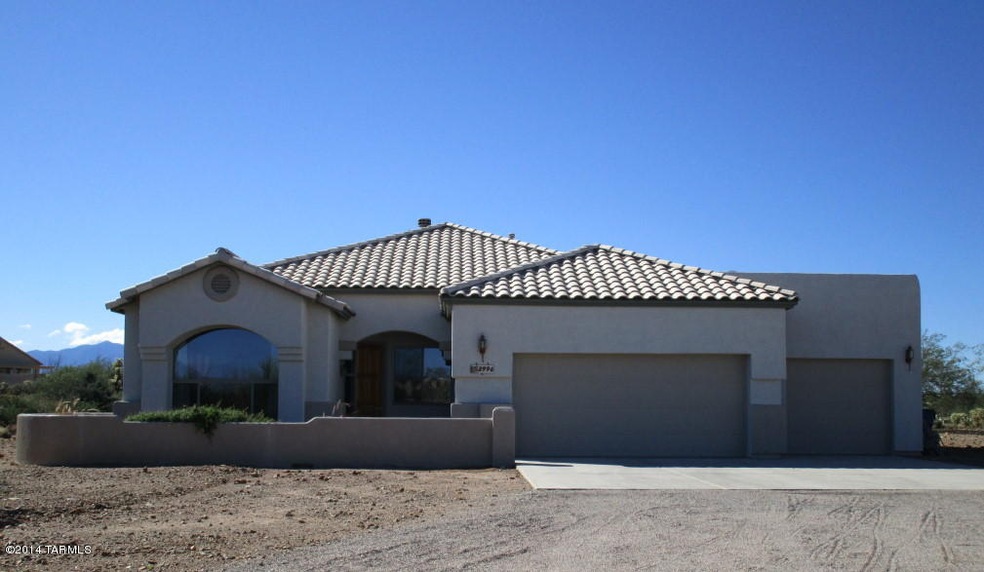 Front View   3 car Garage and Courtyard