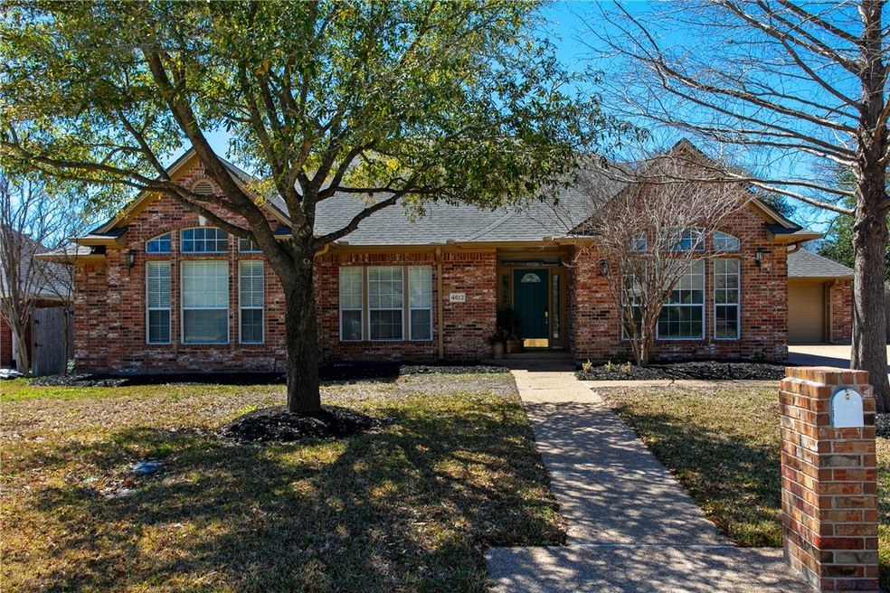 View of front of property with brick siding, a fro