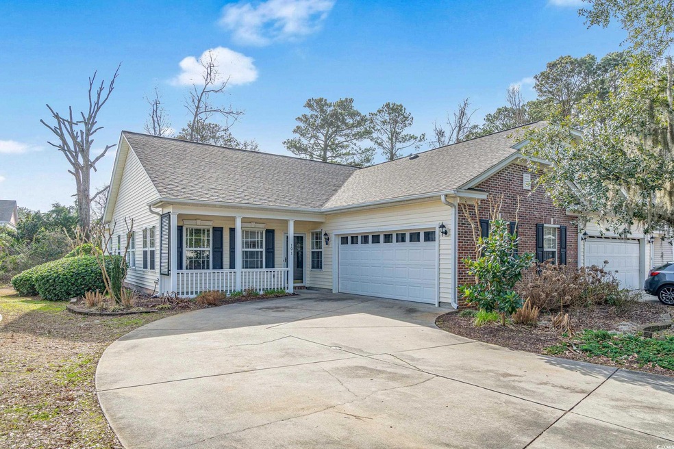 View of front facade featuring a garage and covere