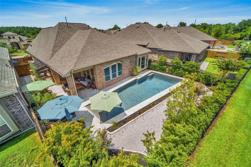 Welcome to 18710 Rend Lake Lane which backs to West Lake in a gated section of Wildwood at Northpointe! Sparkling pool with lush landscaping for privacy!
