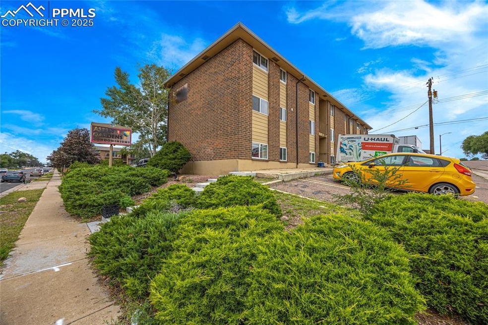 View of property featuring uncovered parking