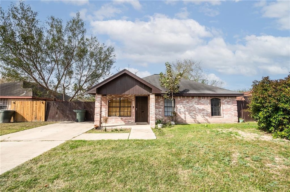 Single story home featuring a front lawn