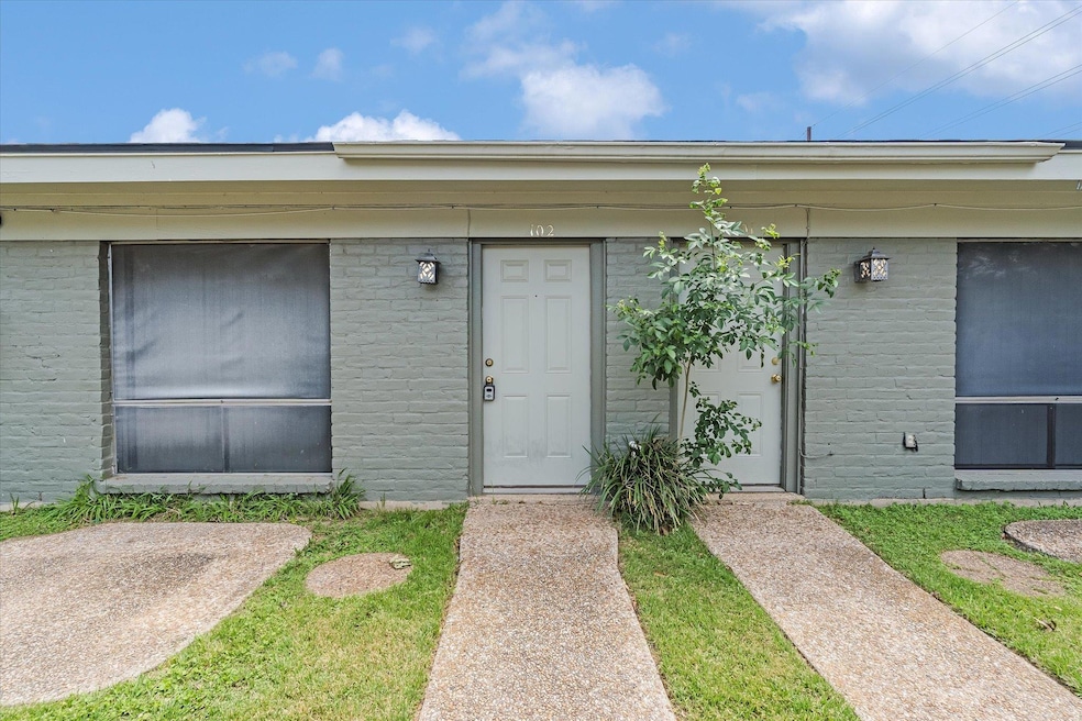 Doorway to property featuring brick siding