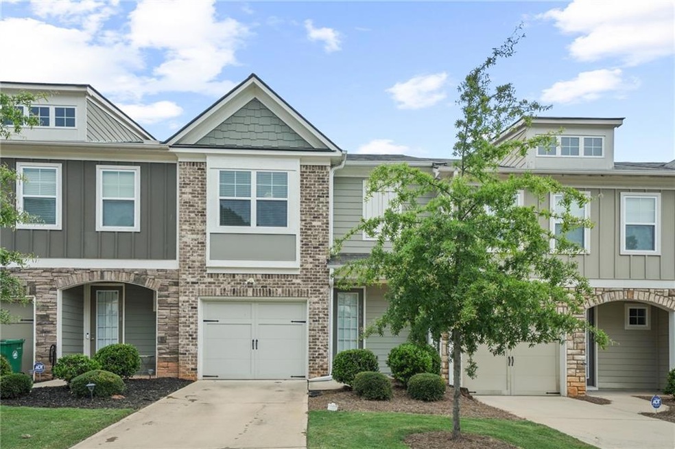 Townhome / multi-family property featuring a garag