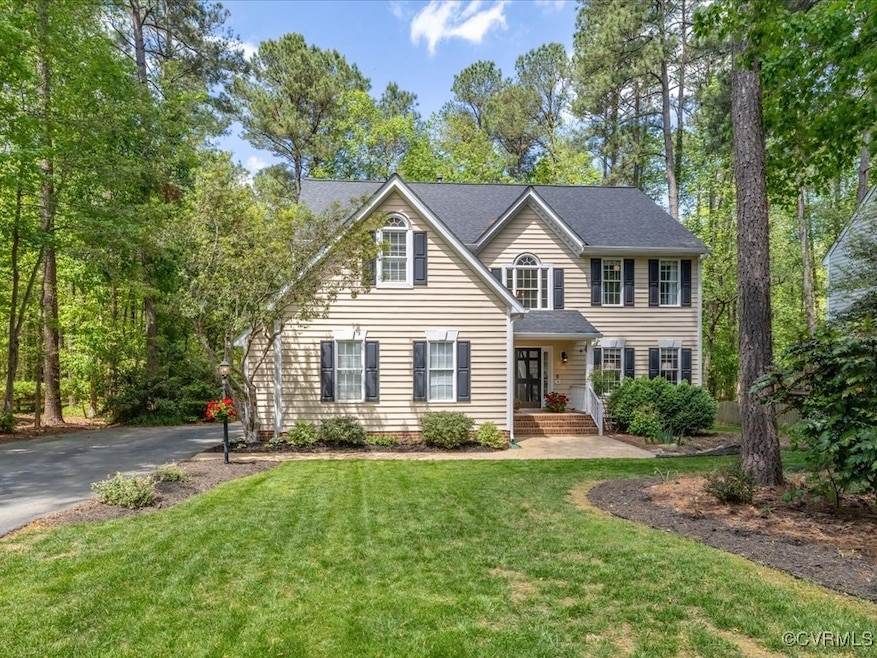 Colonial inspired home featuring a front lawn