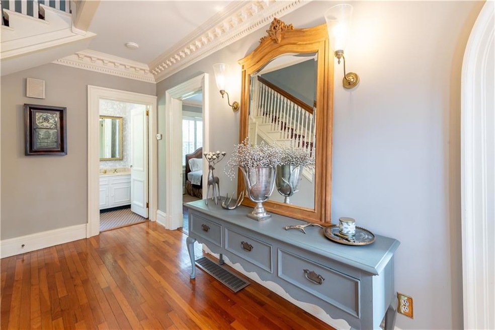 Hall featuring hardwood / wood-style floors and ornamental molding