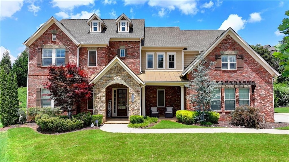 Craftsman-style home with a front yard, roof with shingles, a porch, brick siding, and a standing seam roof