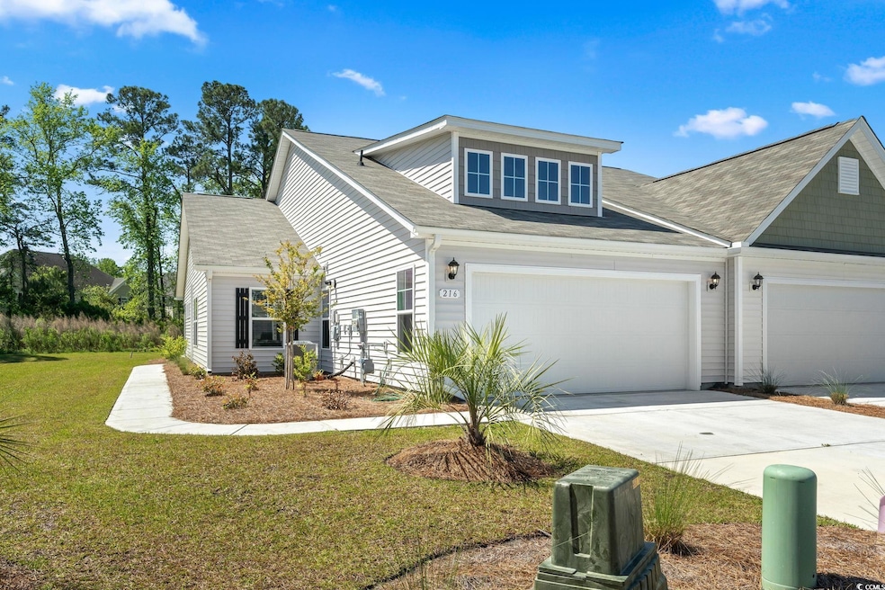 View of front facade featuring driveway, a front l