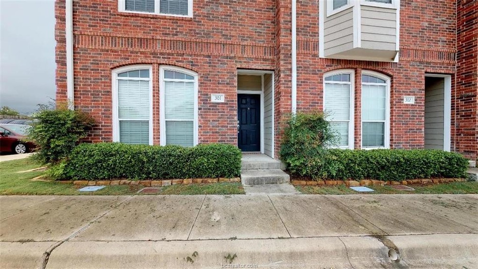 View of exterior entry with brick siding