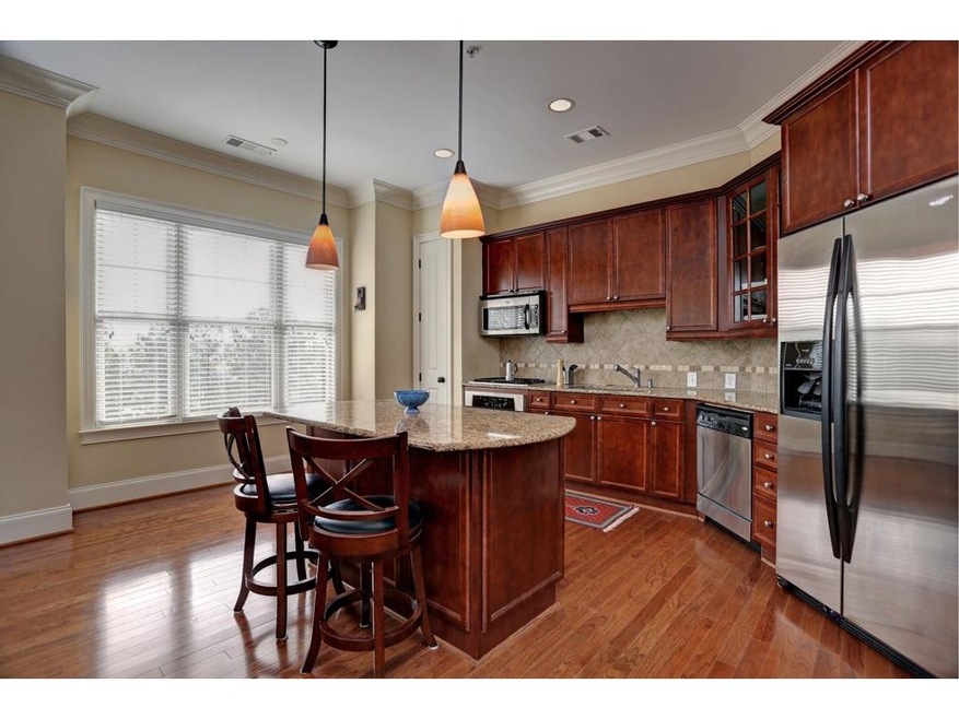Kitchen features stainless steel appliances, grani