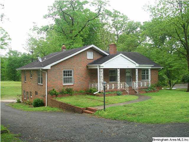Brick and vinyl, driveway goes around to the back 