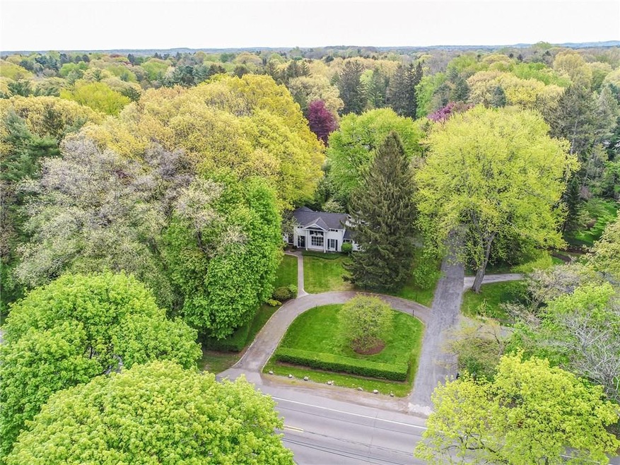 Former Carriage House nestled among trees on 1.28 