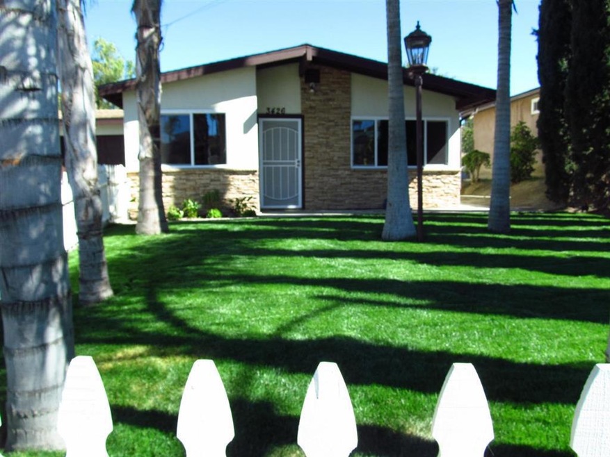 NEW GRASS AND FRESHLY PAINTED FENCE