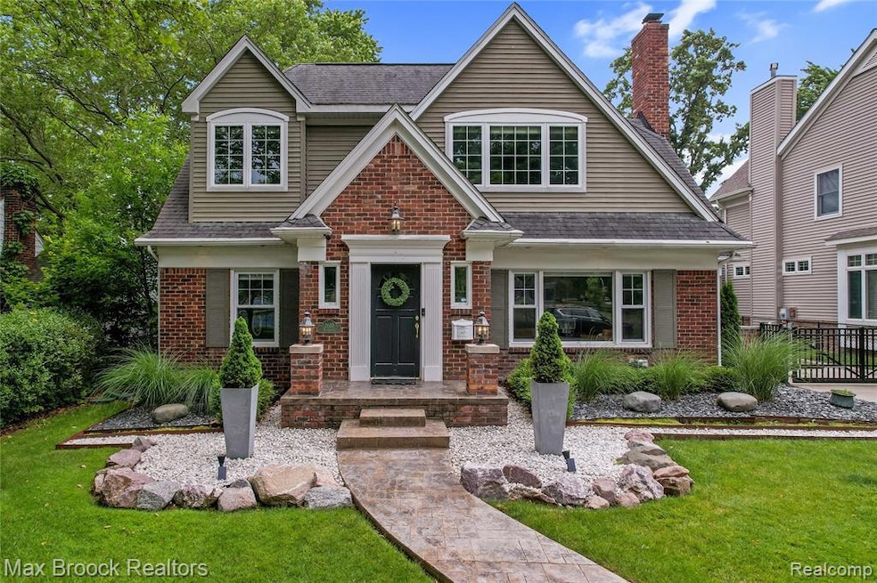 View of front of home with brick siding and a shingled roof