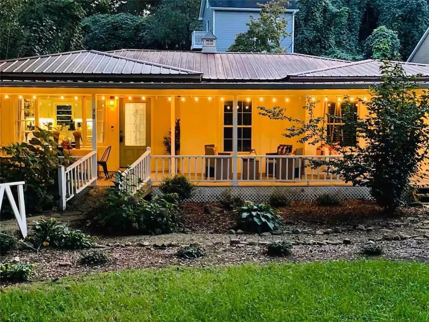 View of front facade with a metal roof and a porch