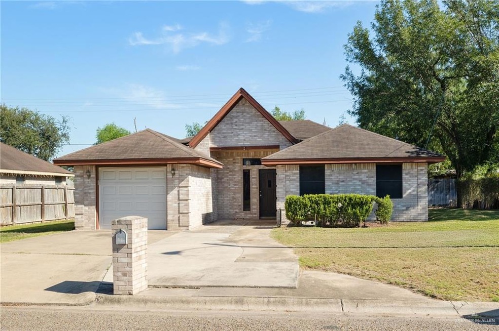 View of front of property featuring concrete driveway, brick siding, an attached garage, and a shingled roof